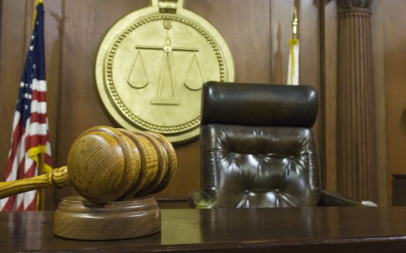 Hammer and gavel near judges chair in court